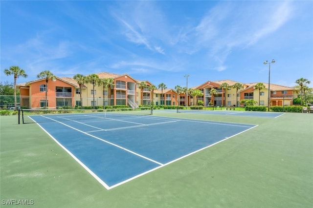6461 Aragon Way Unit 102, Fort Myers, FL 33966 - view of tennis court featuring fence, community basketball court, and a residential view