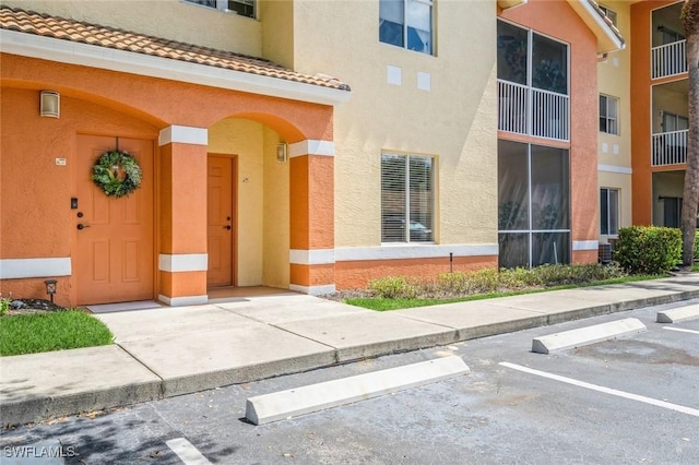 6461 Aragon Way Unit 102, Fort Myers, FL 33966 - view of building exterior with uncovered parking