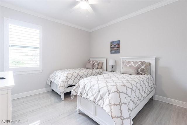 bedroom with baseboards, crown molding, and a ceiling fan