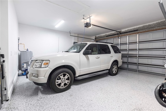 garage featuring a garage door opener and water heater