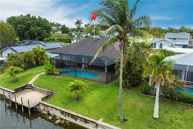 aerial perspective of suburban area featuring a pool and a nearby body of water