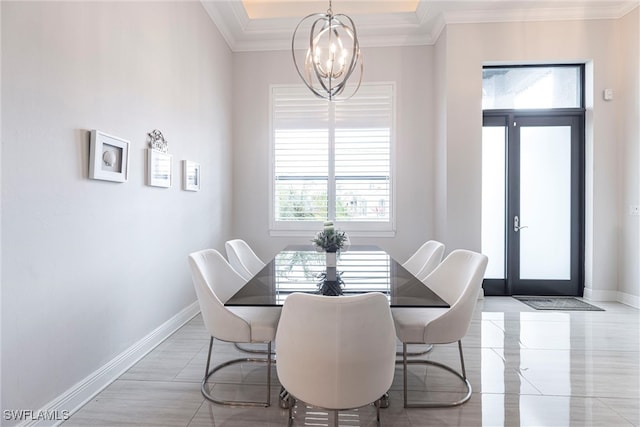 dining room featuring a chandelier, baseboards, and ornamental molding