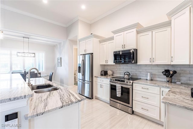 kitchen featuring stainless steel appliances, a sink, crown molding, white cabinets, and tasteful backsplash