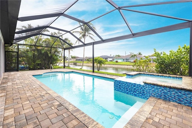 view of pool with a water view, a patio area, a pool with connected hot tub, and a lanai
