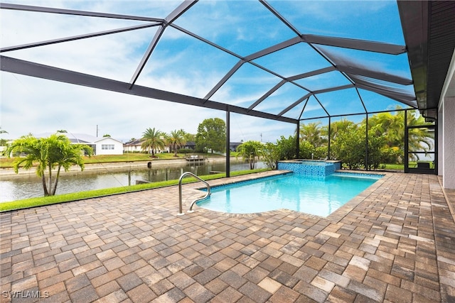 view of swimming pool featuring a patio area, a water view, a pool with connected hot tub, and a lanai