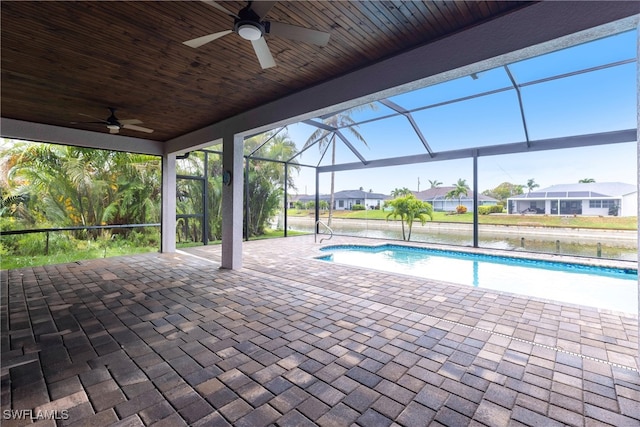 swimming pool with a ceiling fan, a patio area, a lanai, and a residential view
