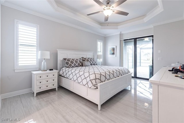 bedroom featuring access to exterior, a tray ceiling, crown molding, ceiling fan, and baseboards