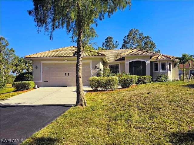 3290 37th Ave NE, Naples, FL 34120 - mediterranean / spanish house with a tile roof, a garage, stucco siding, and a front yard