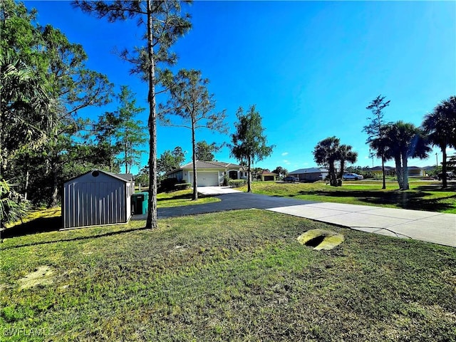 3290 37th Ave NE, Naples, FL 34120 - view of green lawn with driveway, a shed, an attached garage, and an outbuilding