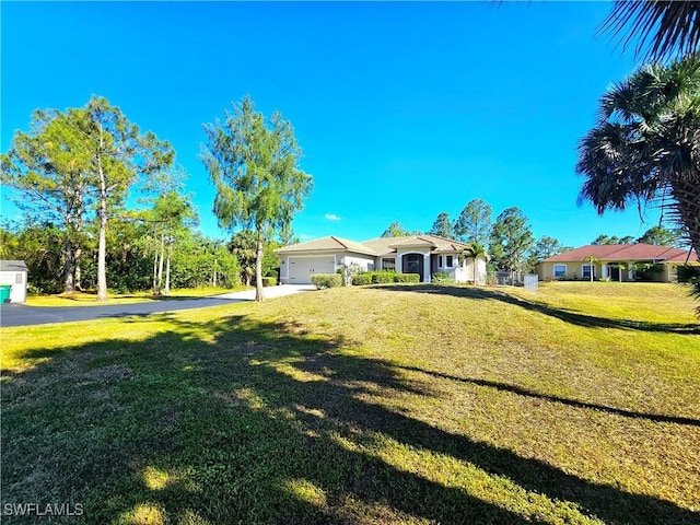 3290 37th Ave NE, Naples, FL 34120 - view of grassy yard with concrete driveway and an attached garage