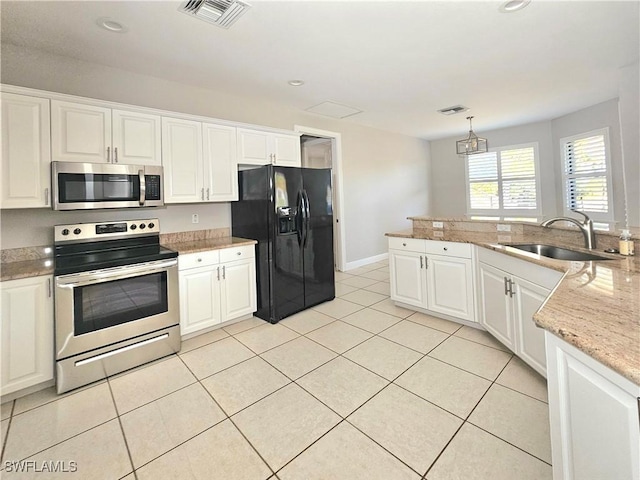 3290 37th Ave NE, Naples, FL 34120 - kitchen with appliances with stainless steel finishes, a sink, light tile patterned flooring, white cabinetry, and recessed lighting
