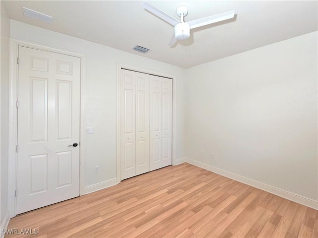3290 37th Ave NE, Naples, FL 34120 - unfurnished bedroom with light wood-type flooring, baseboards, a closet, and a ceiling fan