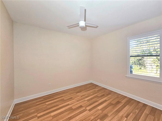 3290 37th Ave NE, Naples, FL 34120 - empty room with light wood-style floors, baseboards, and a ceiling fan