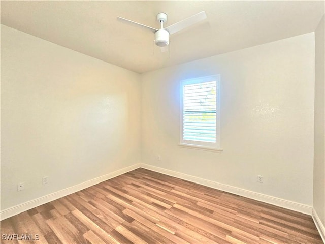 3290 37th Ave NE, Naples, FL 34120 - spare room with baseboards, wood finished floors, and a ceiling fan