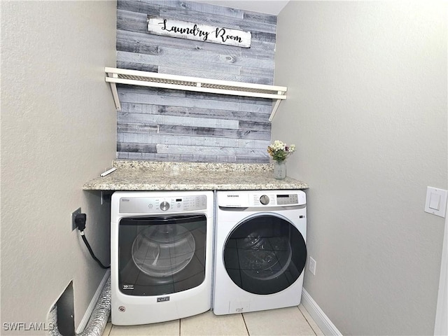 3290 37th Ave NE, Naples, FL 34120 - clothes washing area with washing machine and dryer and light tile patterned flooring