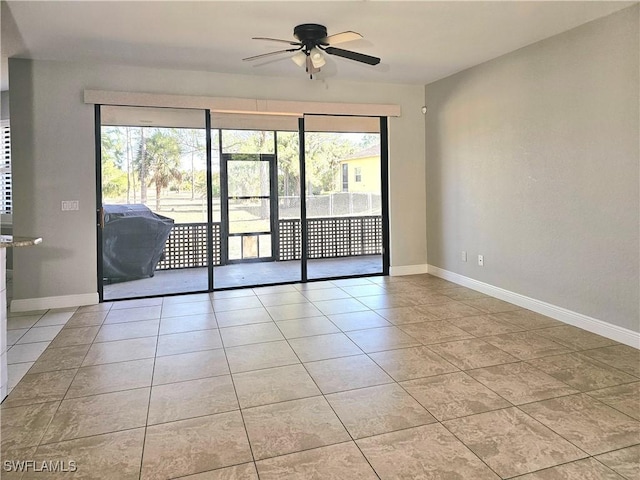 3290 37th Ave NE, Naples, FL 34120 - empty room with ceiling fan, plenty of natural light, baseboards, and tile patterned flooring