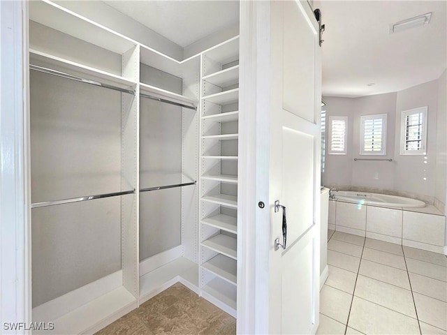 3290 37th Ave NE, Naples, FL 34120 - spacious closet featuring tile patterned flooring
