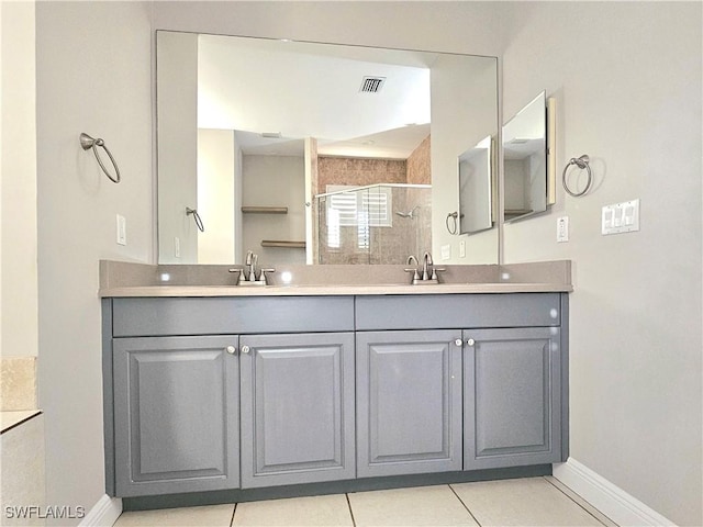 3290 37th Ave NE, Naples, FL 34120 - bathroom with a shower stall, baseboards, double vanity, and tile patterned flooring