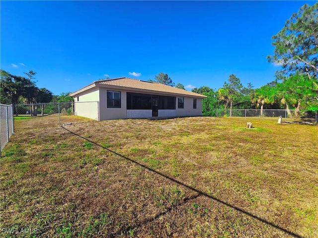 3290 37th Ave NE, Naples, FL 34120 - rear view of property with stucco siding, a tiled roof, and a sunroom