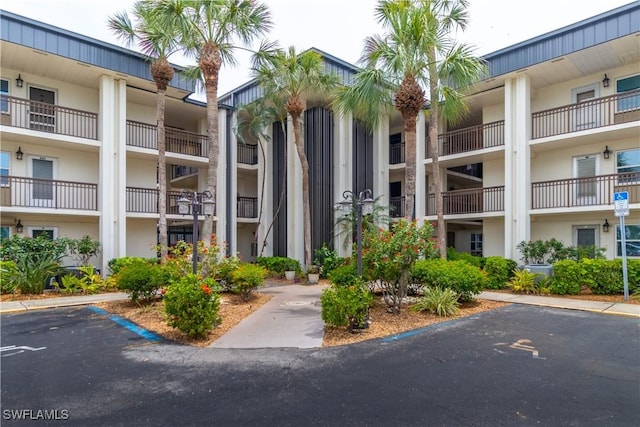1740 Pine Valley Dr Unit 211, Fort Myers, FL 33907 - view of apartment building / complex featuring uncovered parking