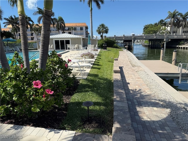 2880 Gulf Shore Blvd N Unit 404, Naples, FL 34103 - dock featuring a community pool, a water view, and a patio
