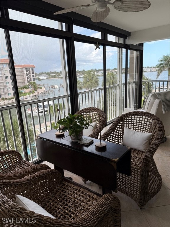 2880 Gulf Shore Blvd N Unit 404, Naples, FL 34103 - sunroom featuring a water view, ceiling fan, and plenty of natural light
