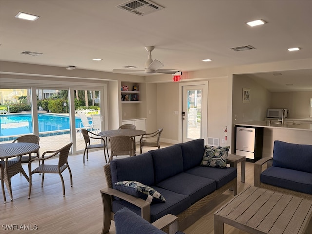 2880 Gulf Shore Blvd N Unit 404, Naples, FL 34103 - living area with ceiling fan, plenty of natural light, light wood finished floors, recessed lighting, and built in shelves