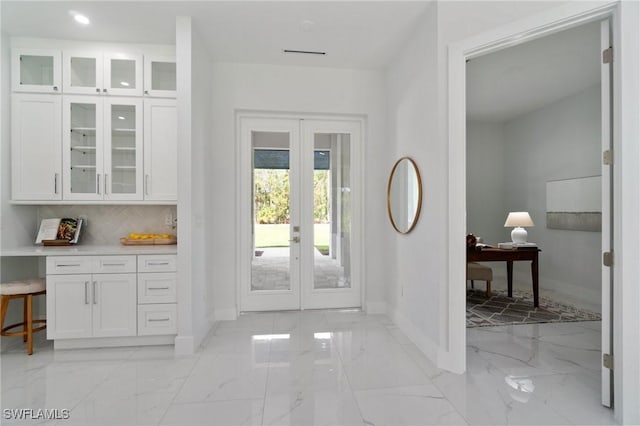 entryway with french doors, baseboards, light marble finish flooring, and recessed lighting