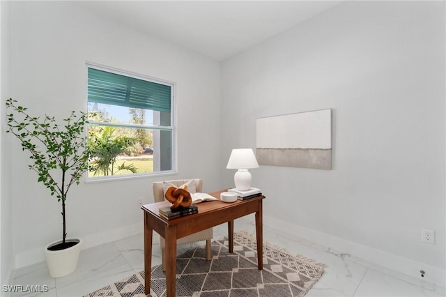 office space featuring marble look tile flooring and baseboards