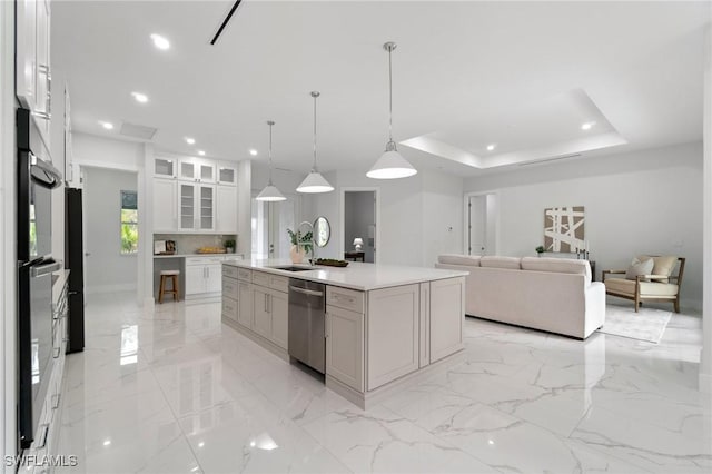 kitchen with stainless steel dishwasher, white cabinetry, glass insert cabinets, open floor plan, and recessed lighting