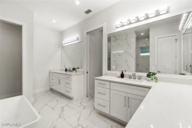 full bath with marble finish flooring, a marble finish shower, baseboards, recessed lighting, and two vanities