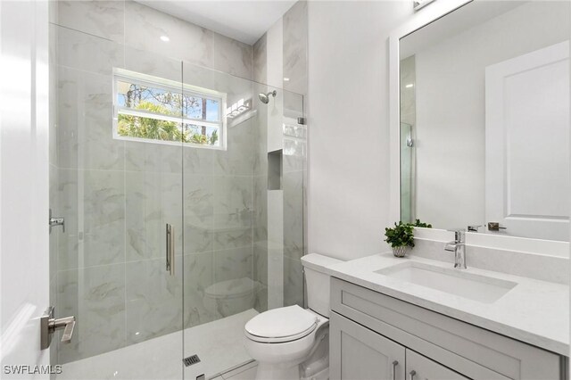 full bath with a shower stall, toilet, and vanity