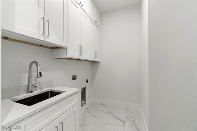 laundry room featuring hookup for an electric dryer, cabinet space, light marble finish floors, baseboards, and washer hookup