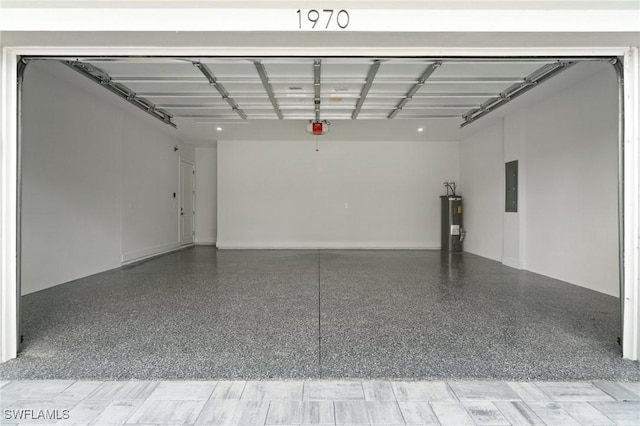 garage featuring electric water heater, electric panel, and a garage door opener