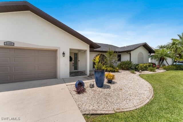 2124 SE 10th Ln, Cape Coral, FL 33990 - ranch-style house featuring stucco siding, a front yard, driveway, and an attached garage