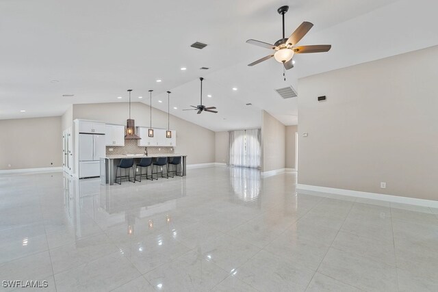 2124 SE 10th Ln, Cape Coral, FL 33990 - unfurnished living room featuring a ceiling fan, light tile patterned floors, baseboards, high vaulted ceiling, and recessed lighting