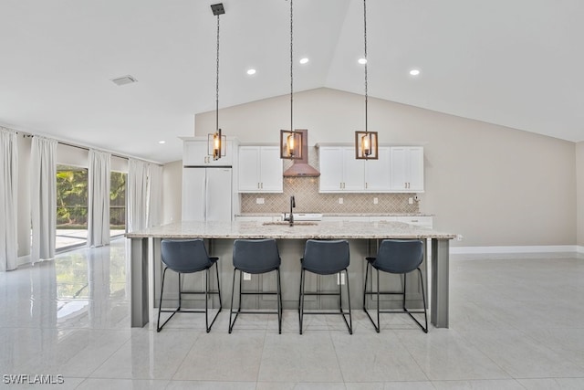 2124 SE 10th Ln, Cape Coral, FL 33990 - kitchen featuring white fridge, a large island, decorative backsplash, lofted ceiling, and white cabinets