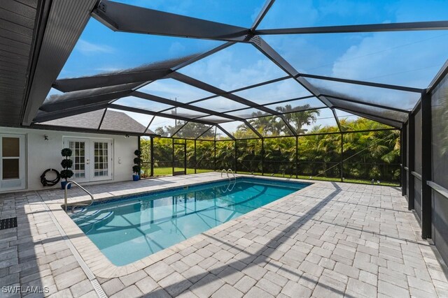 2124 SE 10th Ln, Cape Coral, FL 33990 - swimming pool with french doors, a patio area, and a lanai