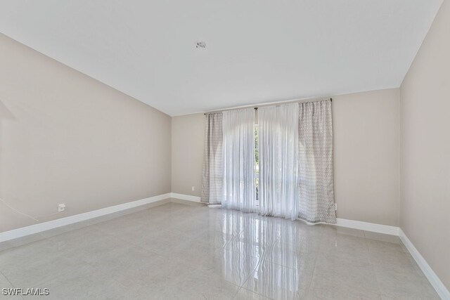 2124 SE 10th Ln, Cape Coral, FL 33990 - empty room featuring baseboards and tile patterned floors