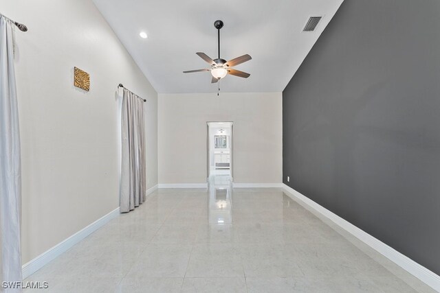 2124 SE 10th Ln, Cape Coral, FL 33990 - spare room with a ceiling fan, lofted ceiling, and baseboards