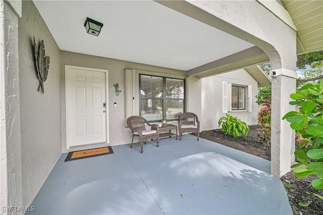 27006 Elaine Dr, Bonita Springs, FL 34135 - doorway to property featuring stucco siding and a patio area