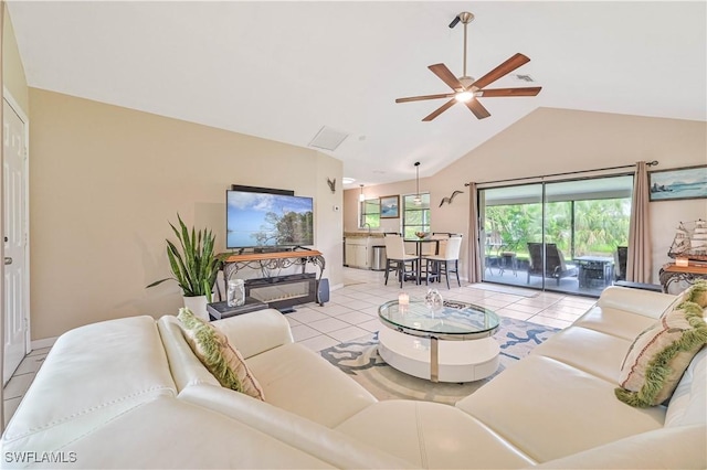 27006 Elaine Dr, Bonita Springs, FL 34135 - living room with light tile patterned flooring, ceiling fan, high vaulted ceiling, and baseboards