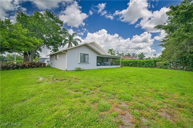 27006 Elaine Dr, Bonita Springs, FL 34135 - rear view of house featuring a lawn, a sunroom, and stucco siding
