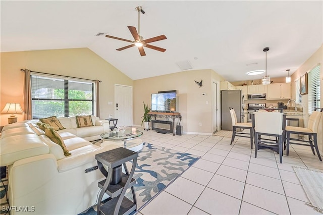 27006 Elaine Dr, Bonita Springs, FL 34135 - living area with ceiling fan, plenty of natural light, lofted ceiling, light tile patterned flooring, and baseboards