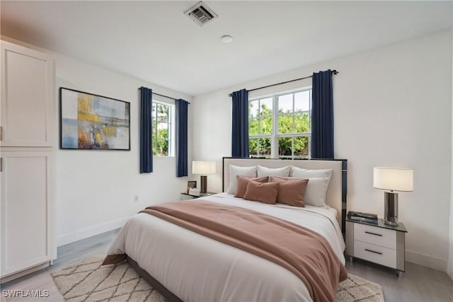 26380 Coco Cay Cir Unit 101, Bonita Springs, FL 34135 - bedroom with baseboards and light wood-style floors