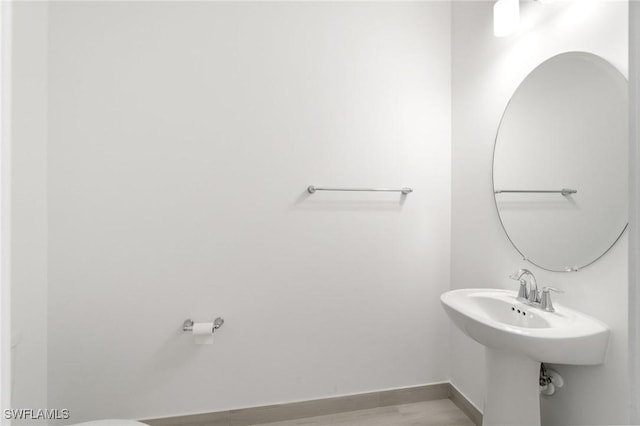 26380 Coco Cay Cir Unit 101, Bonita Springs, FL 34135 - half bathroom featuring baseboards and wood finished floors