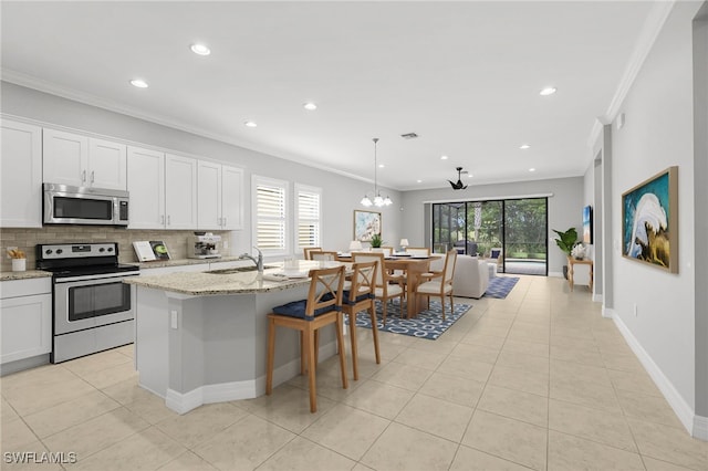 11810 Timbermarsh Ct, Fort Myers, FL 33913 - kitchen with appliances with stainless steel finishes, ornamental molding, light tile patterned floors, backsplash, and recessed lighting