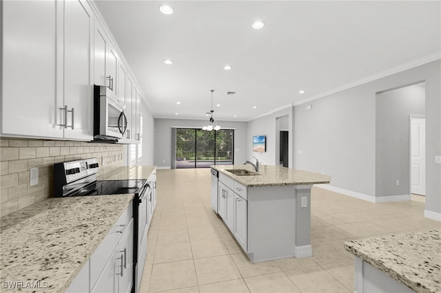 11810 Timbermarsh Ct, Fort Myers, FL 33913 - kitchen featuring appliances with stainless steel finishes, light tile patterned floors, a sink, tasteful backsplash, and white cabinetry