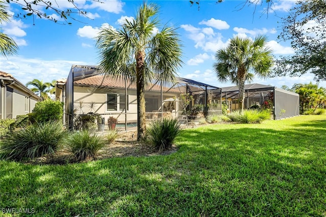 11810 Timbermarsh Ct, Fort Myers, FL 33913 - rear view of house with a lawn, stucco siding, a lanai, and a tiled roof