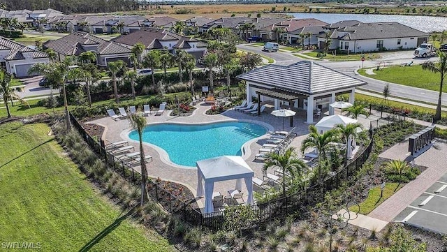 community pool featuring a gazebo, a residential view, and a patio area